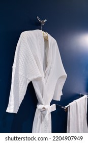 Bathrobe Hanging On Dark Blue Wall