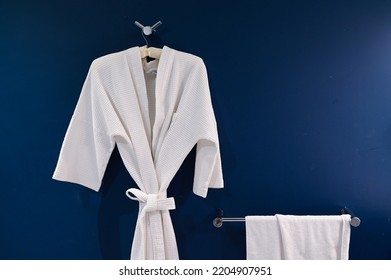 Bathrobe Hanging On Dark Blue Wall