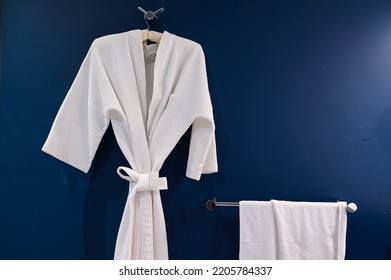 Bathrobe Hanging On Dark Blue Wall