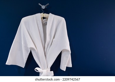 Bathrobe Hanging On Dark Blue Wall