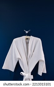 Bathrobe Hanging On Dark Blue Wall