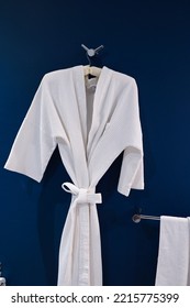 Bathrobe Hanging On Dark Blue Wall