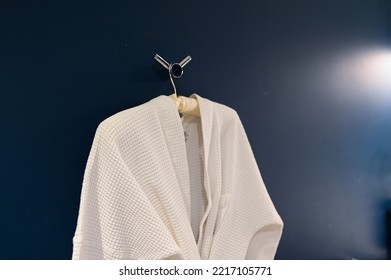 Bathrobe Hanging On Dark Blue Wall