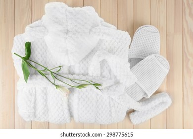 Bathrobe And Slippers On Wooden Table, Top View