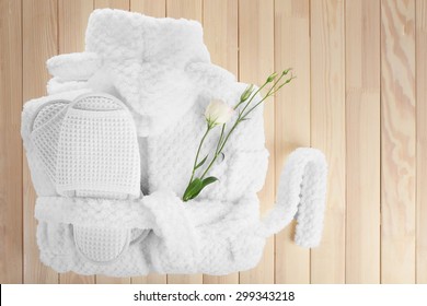 Bathrobe, Towel And Slippers On Wooden Table, Top View