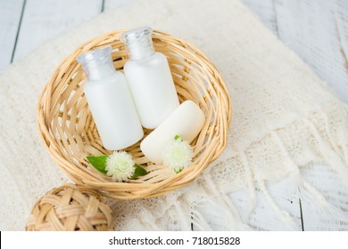 Bathroom accessories. Shower gel, body lotion, shampoo on white wooden background for the bath.