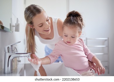 Bathroom, Clean And Washing Hands With Child And Mother Teaching Hygiene With Running Tap Water In Basin. Family, Health And Protection Against Virus With Mom And Baby Learning A Cleaning Routine