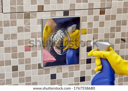 Bathroom cleaning by a professional cleaner. Rubber gloves for cleaning.