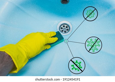 Bathroom Cleaning. A Hand In A Yellow Glove Cleans The Sink. Removal Of Stains And Germs.