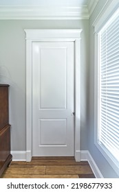 A Bathroom Or Closet Closed White Door In A New Construction House.