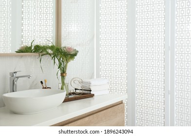 Bathroom Counter With Stylish Vessel Sink And Bouquet. Interior Design