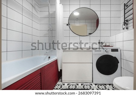 The bathroom is decorated in white, with a rational layout and laundry facilities. The floor is decorated with patterned tiles.