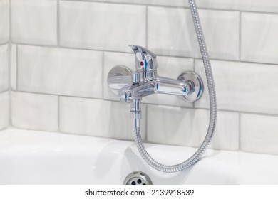 Bathroom Faucet, White Tile And Shower Hose