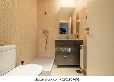 Bathroom With Frameless Mirror, Sink With Dark Wood Cabinet And White Wood Door