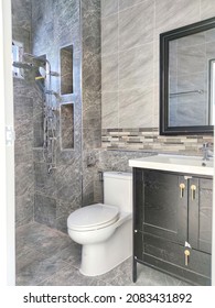 Bathroom interior and design with patterned gray tiles and beautiful garden sanitary ware.