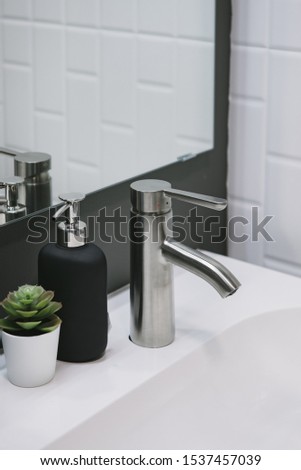Bathroom interior with sink and faucet.