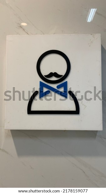 Men’s\
bathroom logo with clean white ceramic\
background