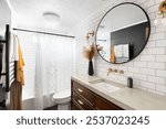 Bathroom photo with classic white subway tile with large concrete top vanity, modern light fixtures, heated towel rack, and white shower curtain.