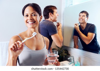 Bathroom Routine For Happy Young Couple Brushing Teeth And Shaving In Mirror