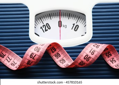 Bathroom scale with measuring tape on white background. Weight loss concept