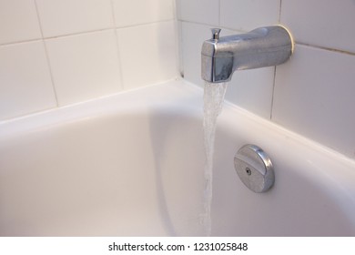  A Bathroom Shower Stall With The Tub Faucet Running Water And Copy Space 