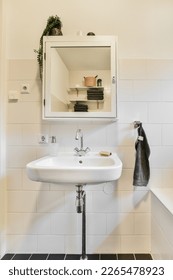 un cuarto de baño con lavabo, espejo y toalla colgado en la pared frente al lavabo es blanco y negro
