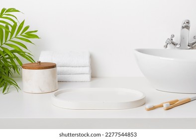Bathroom sink table with empty stand and morning hygiene accessories - Shutterstock ID 2277544853