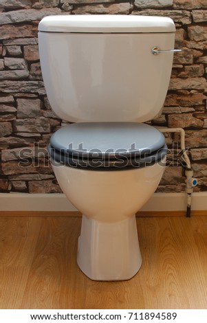 Bathroom toilet with seat down.