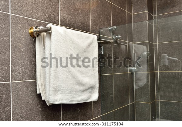 Bathroom\
Towel - white towel on a hanger prepared to\
use