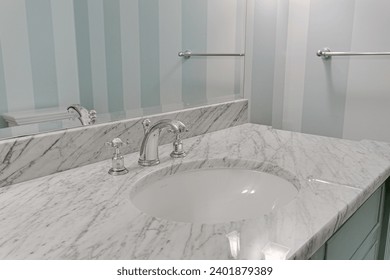 Bathroom Vanity with White Marble Countertop and Undermount Sink Paired with Chrome Fixtures and Striped Pastel Blue Wall Design