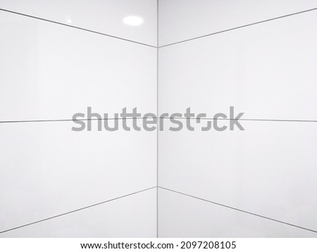 The bathroom walls with white tiles background