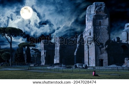 Baths of Caracalla at night, Rome, Italy. Spooky Ancient ruins in full moon on Halloween. Scary gloomy view of haunted destroyed houses, dark creepy mystic place. Mystery, horror and history concept.