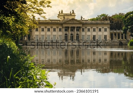 Baths classicist Palace on the Isle in Lazienki Park touristic place in Warsaw. Lazienki Royal Baths Park, Baroque columns Warsaw Poland. Mirror Reflection on the Lake