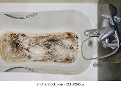 A Bathtub With Dirt Due To A Clogged Sewer Pipe And Poor Drainage, Close-up