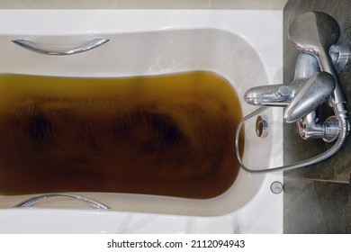 A Bathtub Filled With Dirty Water Due To A Clogged Sewer Pipe, Close-up