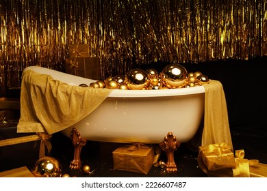 Bathtub full of golden balls. Vintage bright bathroom decorated with festive golden balls. New Year, Christmas bathroom interior. - Shutterstock ID 2226607487