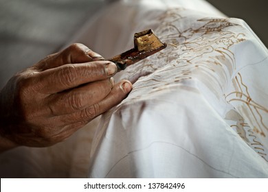 Batik Painting On A White Cloth Process Close Up. Indonesia