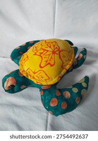 A batik patchwork doll is a handmade toy crafted from pieces of batik fabric. It reflects traditional Indonesian artistry and creative use of fabric scraps. These dolls are unique, colorful, and often used as toys, decorations, or cultural souvenirs.