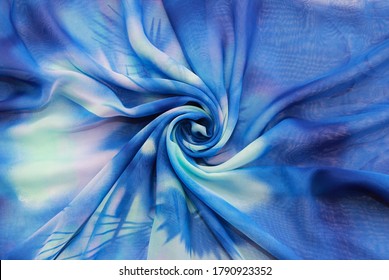 batik patterns and ornaments on blue fabric