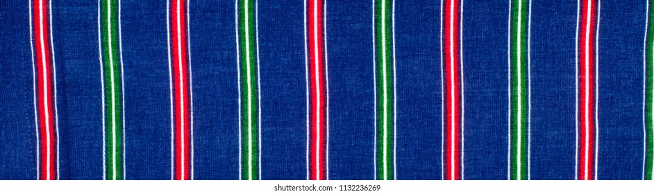 Batiste fabric texture. striped coloring, red green blue white stripes