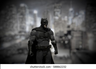 Batman DC Multiverse Series Action Figure Standing In Front Of A Gotham City Backdrop