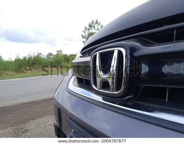 Batola, South\
Kalimantan, Indonesia - July 6, 2021: The Honda logo on one of the\
cars parked on the side of the\
road.