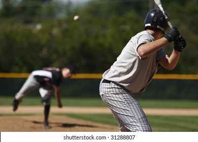 A batter about to hit a pitch during a baseball game.