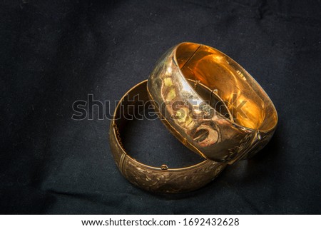 Battered and aged gold bangle bracelets