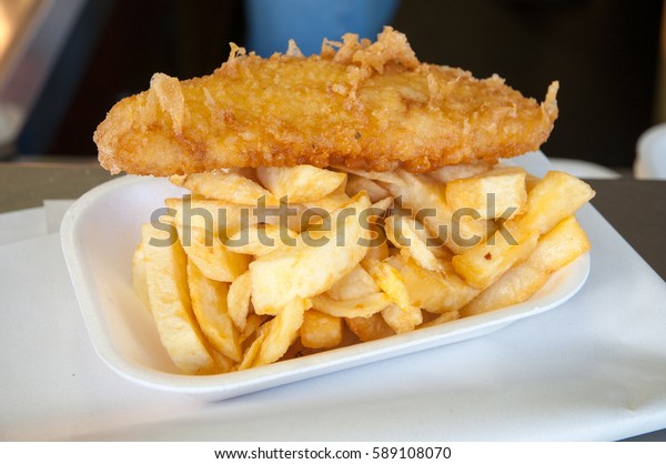 Battered cod and\
chips in chip shop, England,\
UK