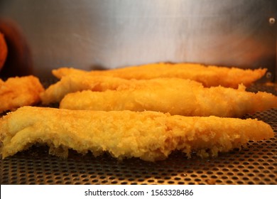 Battered cod on display in a heater in the chip shop