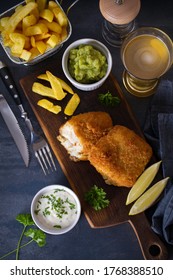 Battered Fish With French Fries, Mushy Peas And Sauce. Fish And Chips, Glass Of Beer. Overhead Vertical Image