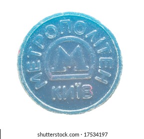 Battered Soviet metro token on white