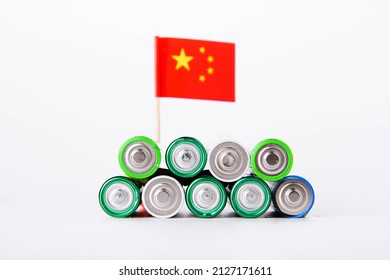 Battery. A Lot Of Batteries On The Background Of The Flag Of The China. Alkaline And Alkaline Battery. Zinc And Salt Battery. Lithium Import. Waste Disposal.