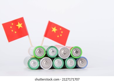 Battery. A Lot Of Batteries On The Background Of The Flag Of The China. Alkaline And Alkaline Battery. Zinc And Salt Battery. Lithium Import. Waste Disposal.